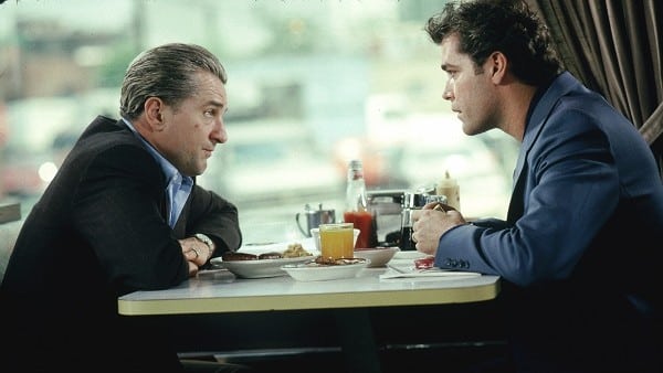 Left to right: Robert De Niro as James Conway sitting in restaurant booth with Ray Liotta as Henry Hill.